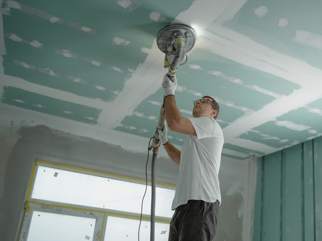 man working on ceiling